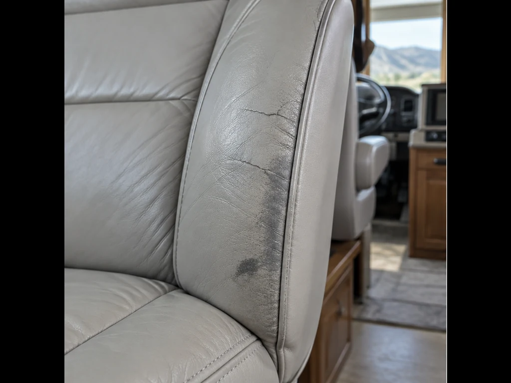 Illustrative view of cracks on a light gray RV captain chair bolster